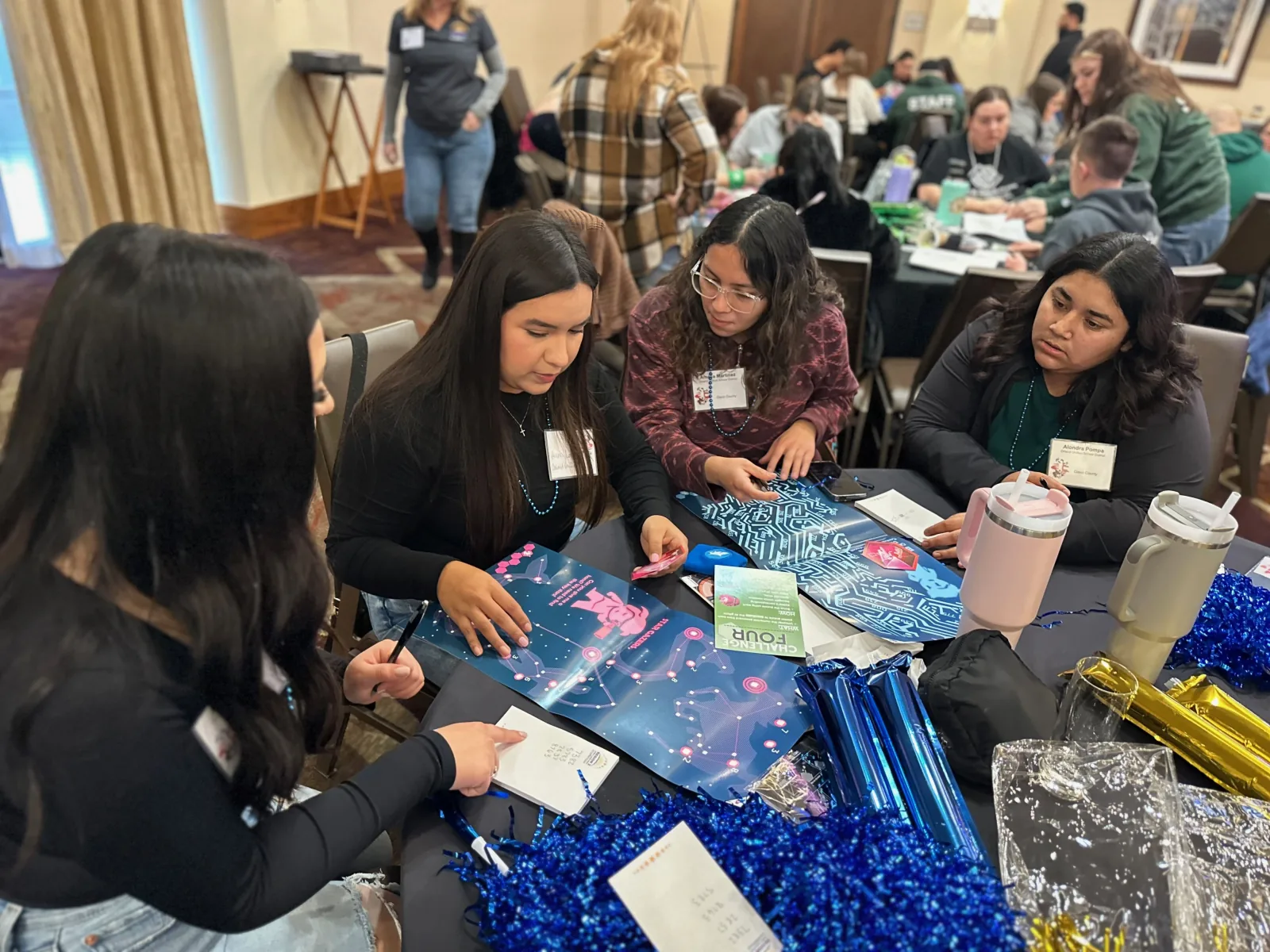 A team working an UNLOCK challenge together at the table